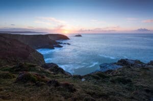 Looking towards Godrevy Lighthouse from the Knavocks on the Cornwall coast at sunset.