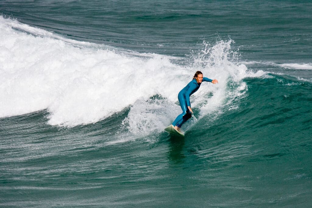 A surfer on the waves at Fistral Beach, Newquay, Cornwall