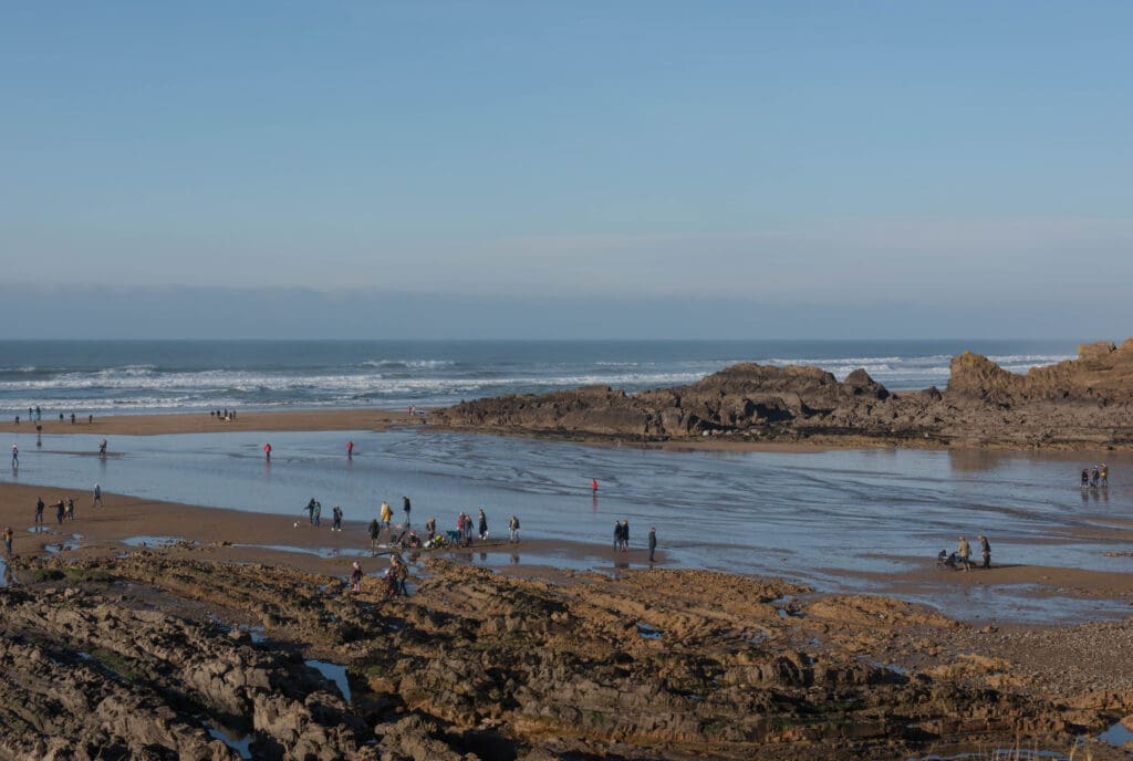 People enjoying the winter sun on Summerleaze Beach, Bude, Cornwall